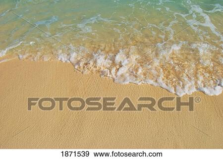Stock Photo - water washing up on the sand. Fotosearch