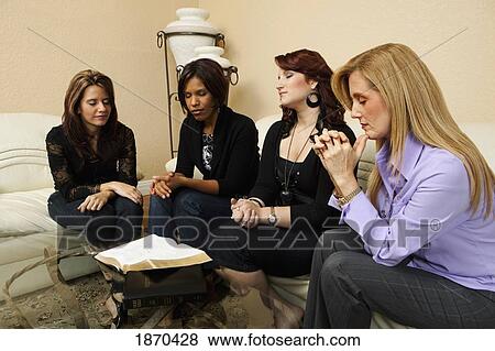 women holding hands and praying together View Large Photo Image Stock Photo - women holding hands and praying together. Fotosearch