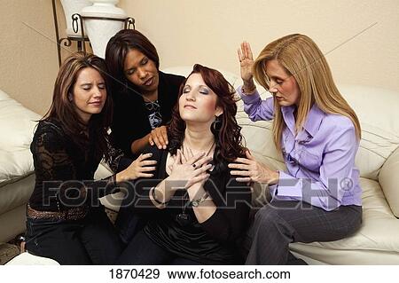 Stock Photo - women praying for a friend. Fotosearch