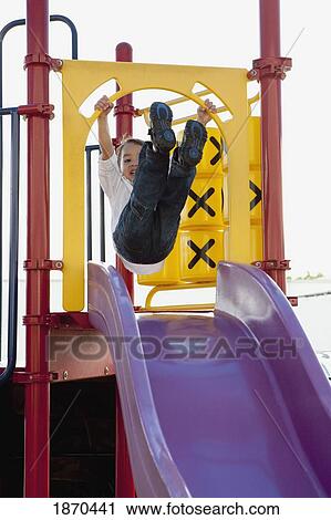 young boy playing at the playground View Large Photo Image Stock Image - young boy playing at the playground. Fotosearch