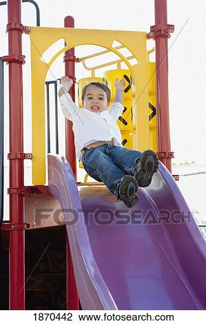 Stock Image - young boy playing at the playground. Fotosearch