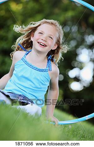 young girl playing with a hula hoop View Large Photo Image Stock Photograph - young girl playing with a hula hoop. Fotosearch