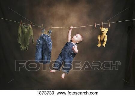 Stock Image - a baby on the clothesline. Fotosearch