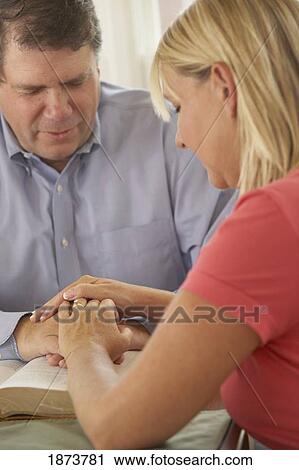 Stock Image - a couple praying together. Fotosearch