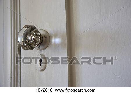 Stock Photo - a crystal doorknob and keyhole on a white door. Fotosearch