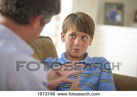 Stock Photo - a father disciplining his son. Fotosearch