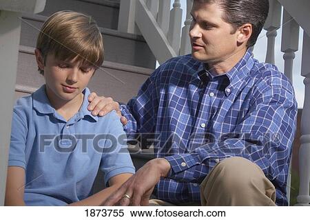 Stock Photography - a father praying with his son. Fotosearch