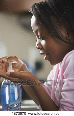 a girl pumping soap to wash her hands View Large Photo Image Stock Image - a girl pumping soap to wash her hands. Fotosearch