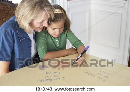 a girl with her mother drawing a picture saying 'i am thankful for my family' View Large Photo Image Stock Image - a girl with her mother drawing a picture saying 'i am thankful for my family'. Fotosearch
