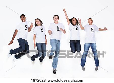 Stock Photo - a group of teenagers jumping in the air with their t-shirts spelling 'peace'. Fotosearch