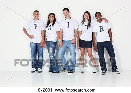 Stock Image - a group of teenagers with t-shirts spelling 'faith'. Fotosearch