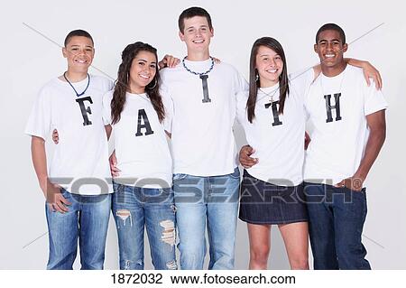 Stock Image - a group of teenagers with their t-shirts spelling 'faith'. Fotosearch