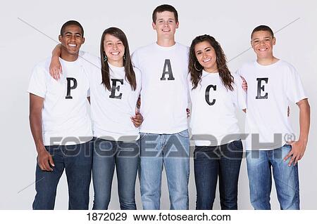 Stock Photo - a group of teenagers with their t-shirts spelling 'peace'. Fotosearch