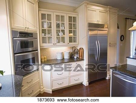 Stock Image - a kitchen with stainless steel appliances. Fotosearch