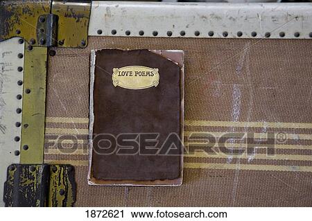 Stock Image - a love poems book on an antique trunk. Fotosearch