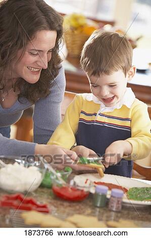 a mother and son decorating cookies together View Large Photo Image Stock Photograph - a mother and son decorating cookies together. Fotosearch