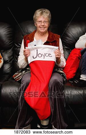 a woman holding her large stocking View Large Photo Image Stock Image - a woman holding her large stocking. Fotosearch