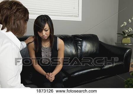 a woman praying for a young woman View Large Photo Image Stock Photograph - a woman praying for a young woman. Fotosearch