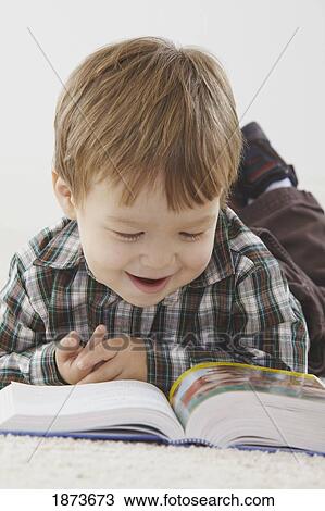 a young boy reading his bible View Large Photo Image Stock Image - a young boy reading his bible. Fotosearch