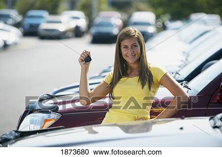 a young woman with keys to a vehicle in a car dealership View Large Photo Image Stock Image - a young woman with keys to a vehicle in a car dealership. Fotosearch
