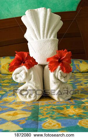 Stock Image - akumal, mexico; towels folded for decoration on a bed in a hotel room. Fotosearch