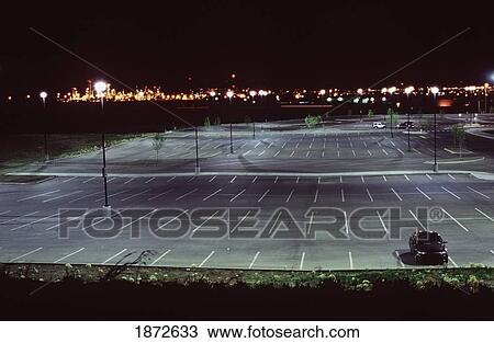 an almost empty parking lot illuminated at night View Large Photo Image Stock Image - an almost empty parking lot illuminated at night. Fotosearch