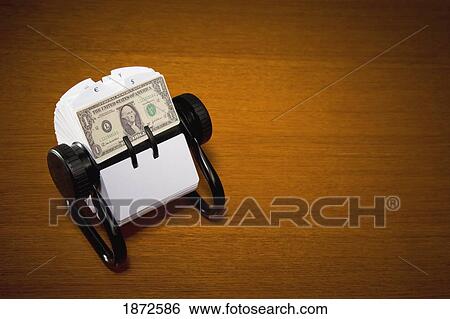 Stock Photograph - an american dollar bill in a rolodex. Fotosearch