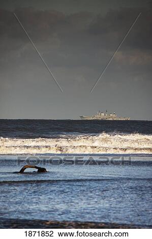 cresswell, northumberland, england; a ship in the distance from the shore with storm clouds overhead View Large Photo Image Stock Image - cresswell, northumberland, england; a ship in the distance from the shore with storm clouds overhead. Fotosearch