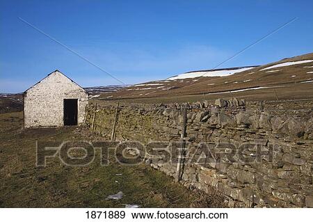 Stock Photo - durham dales, county dales, england; a building and fence with traces of snow on the ground. Fotosearch