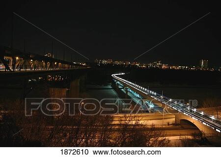 Stock Image - edmonton, alberta, canada; the high level bridge and the lrt bridge going over the north saskatchewan river at night. Fotosearch