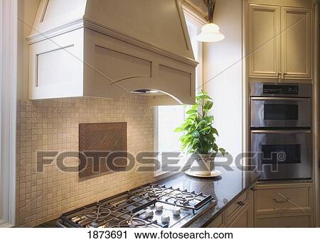 hood over a cook top stove in a kitchen View Large Photo Image Stock Image - hood over a cook top stove in a kitchen. Fotosearch
