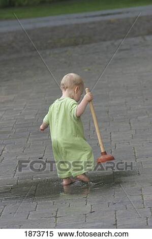 jordan, ontario, canada; a toddler playing in a puddle with a toilet plunger View Large Photo Image Stock Photography - jordan, ontario, canada; a toddler playing in a puddle with a toilet plunger. Fotosearch