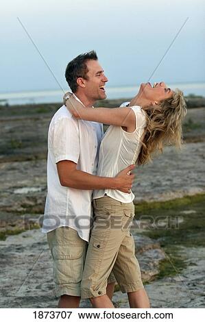 port colborne, ontario, canada; a couple in an embrace standing on the beach View Large Photo Image Stock Photo - port colborne, ontario, canada; a couple in an embrace standing on the beach. Fotosearch