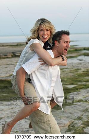 Stock Photo - port colborne, ontario, canada; a couple enjoying time together on the beach. Fotosearch