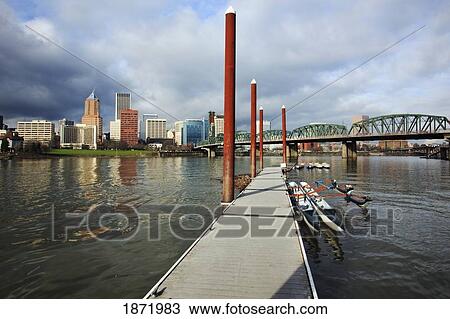 Stock Image - portland, oregon, united states of america; boats docked on a pier on the willamette river and downtown portland. Fotosearch