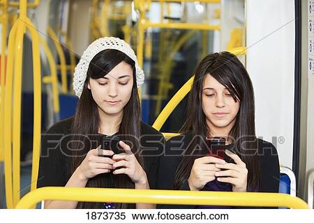 portland, oregon, united states of america; two teenage girls using their cell phones View Large Photo Image Stock Photography - portland, oregon, united states of america; two teenage girls using their cell phones. Fotosearch