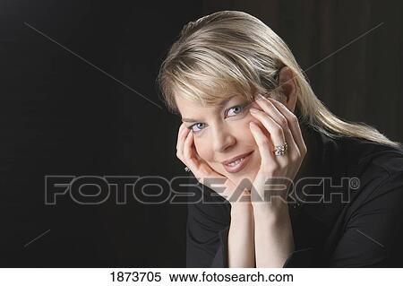 portrait of a woman holding her face in her hands View Large Photo Image Stock Photography - portrait of a woman holding her face in her hands. Fotosearch