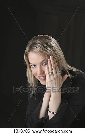 portrait of a woman holding her hands up by her face View Large Photo Image Stock Photograph - portrait of a woman holding her hands up by her face. Fotosearch