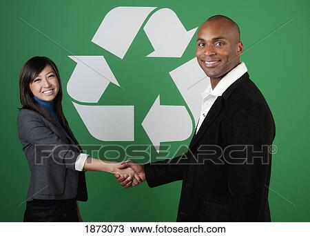 two business people shaking hands in front of a recycle symbol View Large Photo Image Stock Image - two business people shaking hands in front of a recycle symbol. Fotosearch