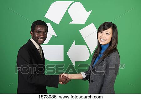 two business people shaking hands in front of a recycle symbol View Large Photo Image Stock Photograph - two business people shaking hands in front of a recycle symbol. Fotosearch