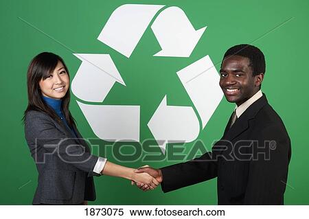 two business people shaking hands in front of a recycle symbol View Large Photo Image Stock Photography - two business people shaking hands in front of a recycle symbol. Fotosearch