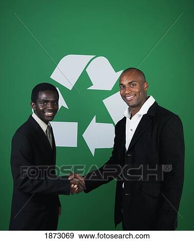 Stock Photo - two businessmen shaking hands in front of a recycle symbol. Fotosearch