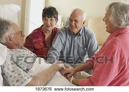 visiting an elderly father in the hospital View Large Photo Image Stock Photograph - visiting an elderly father in the hospital. Fotosearch