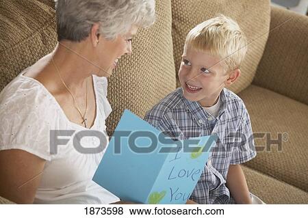 a boy giving a card saying "i love you" to his grandmother View Large Photo Image Stock Photo - a boy giving a card saying "i love you" to his grandmother. Fotosearch