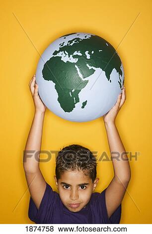 Stock Photo - a boy holding a globe. Fotosearch