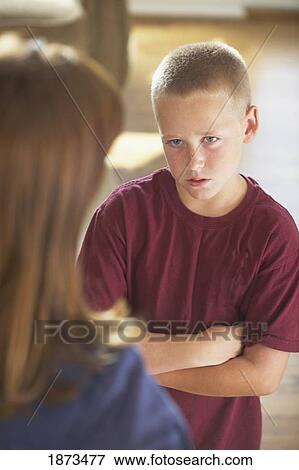 a boy looking at his mother with his arms crossed View Large Photo Image Stock Photo - a boy looking at his mother with his arms crossed. Fotosearch