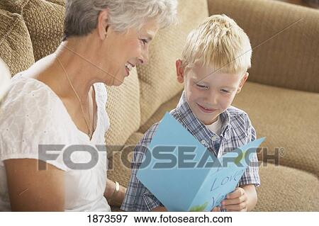 a boy reading a card that says "i love you" to his grandmother View Large Photo Image Stock Photo - a boy reading a card that says "i love you" to his grandmother. Fotosearch