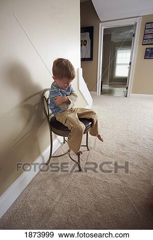 a boy sitting in a chair for discipline View Large Photo Image Stock Photo - a boy sitting in a chair for discipline. Fotosearch