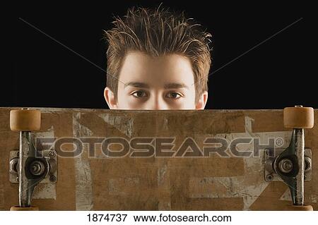 Stock Photo - a boy with a skateboard. Fotosearch