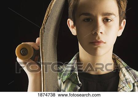 Stock Photo - a boy with a skateboard. Fotosearch